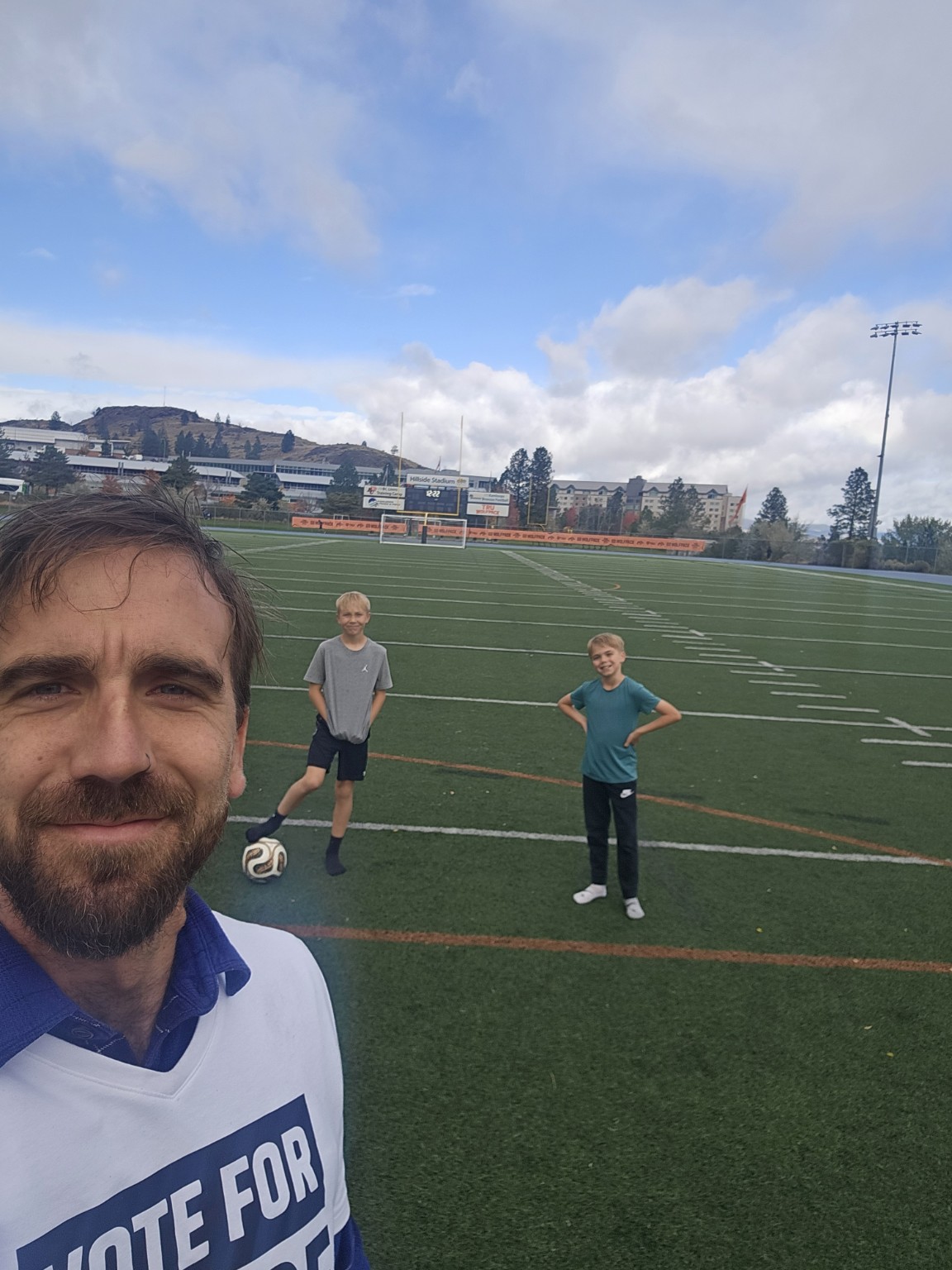 Bryce with his two children on the soccer field at TRU